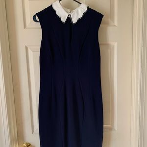 Sleeveless navy dress with scalloped neckline.